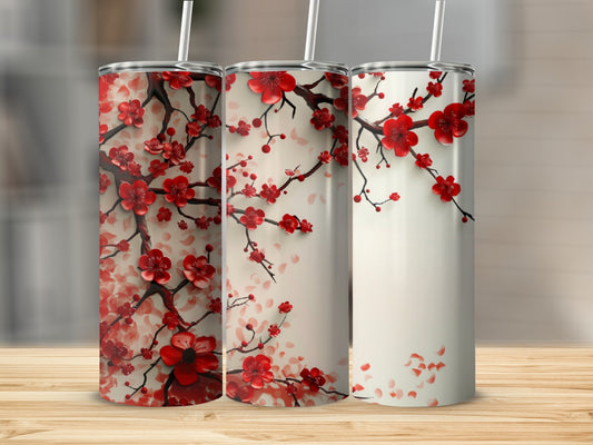 Three tumblers with red cherry blossoms against a wooden surface.
