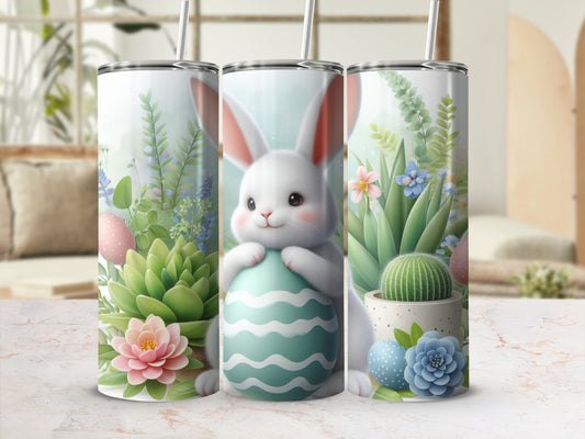 White bunny hugs teal egg with succulents and flowers.