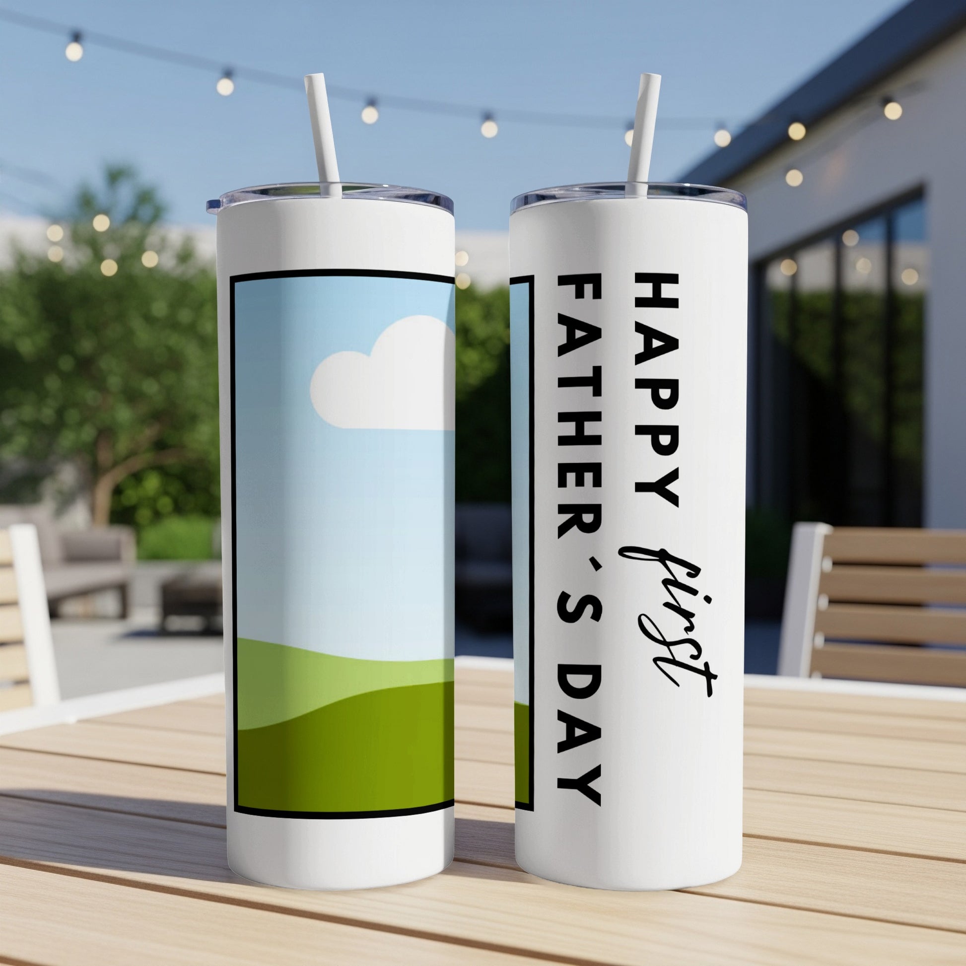 Two tumblers with straws sit on a table, one reads "Happy first Father's Day."