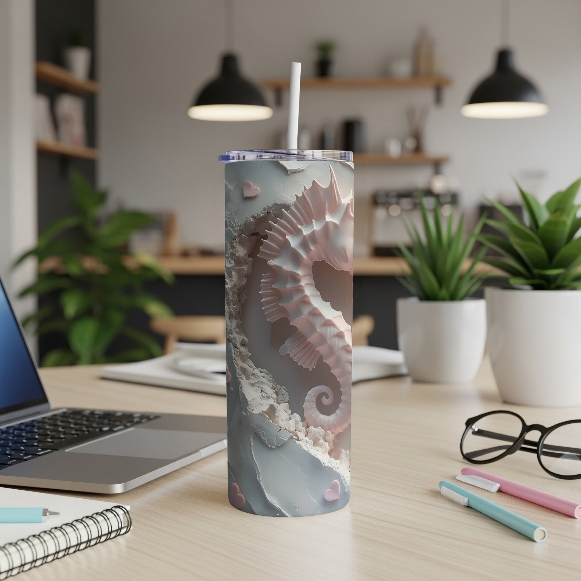 Pale pink seahorse pattern on a white and gray tumbler with a straw.