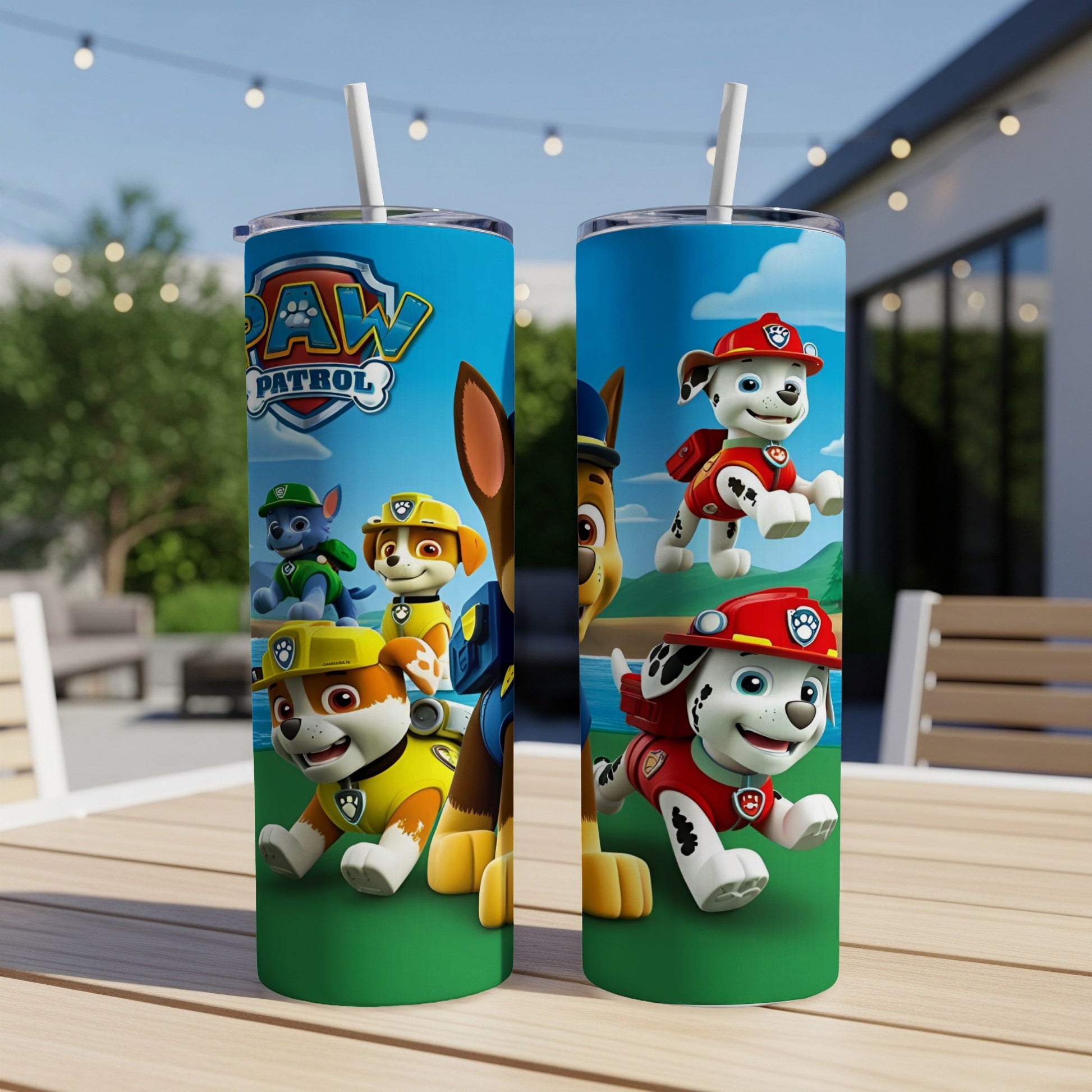 Paw Patrol characters on two blue tumblers with straws on a wooden table.
