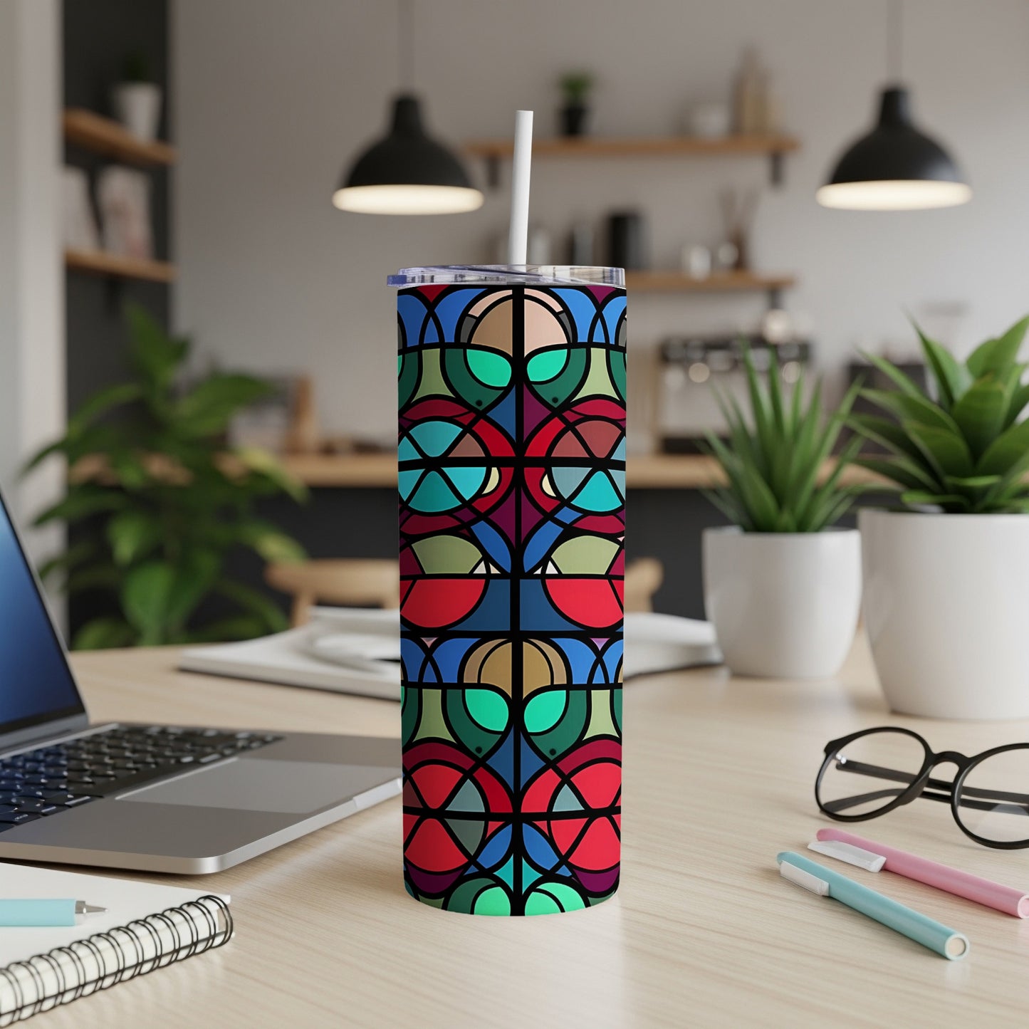 Geometric stained-glass pattern on a stainless steel tumbler with straw.