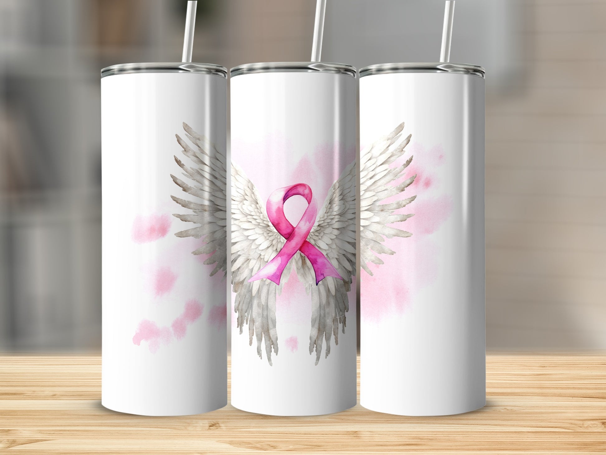 Three white tumblers with pink angel wings and a breast cancer ribbon.