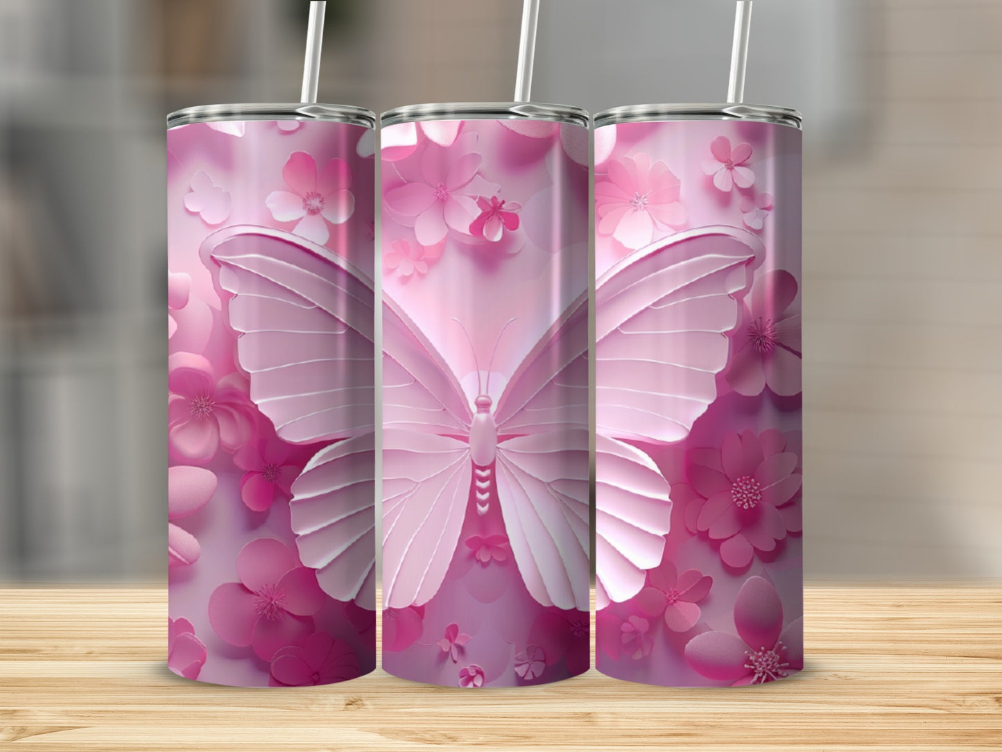 Three pink tumblers with butterfly and flower designs.