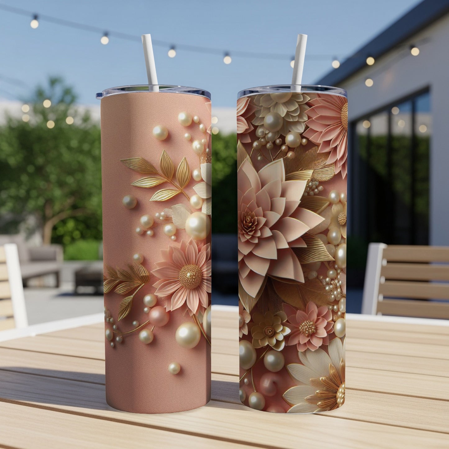 Two rose gold tumblers with floral pearl embellishments on a wooden table.