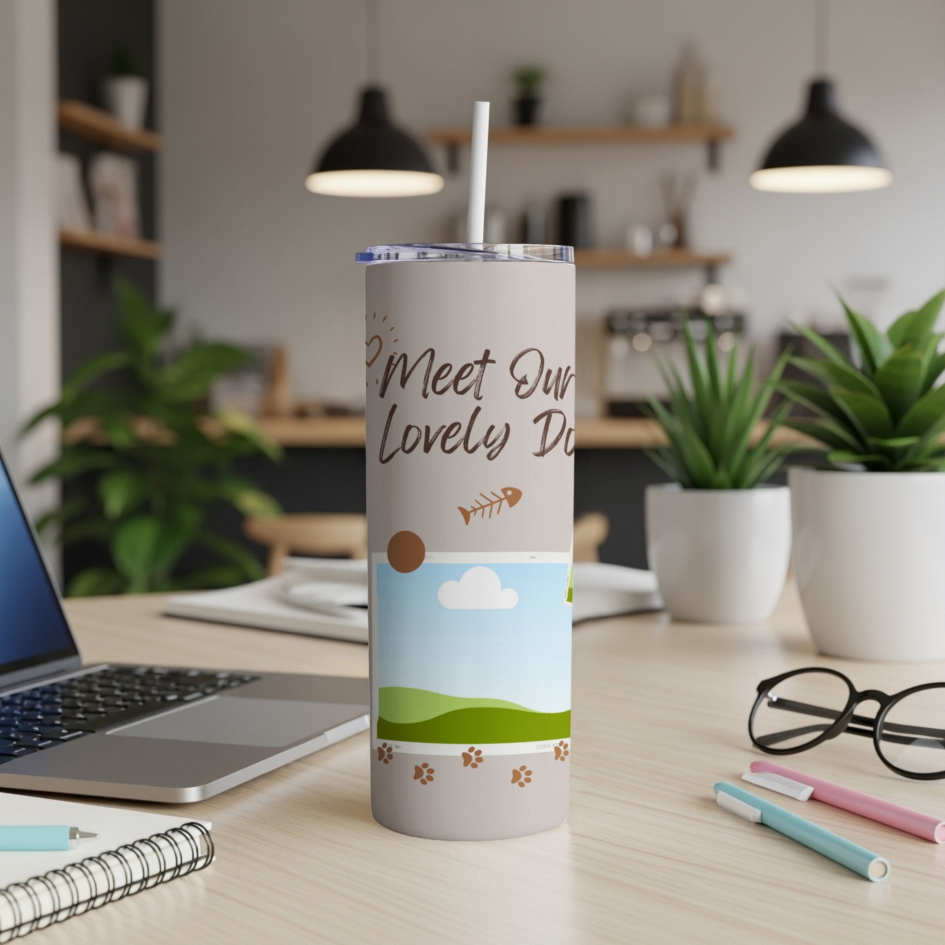 Tumbler with "Meet Our Lovely Do" text, fish, paw prints, and landscape.