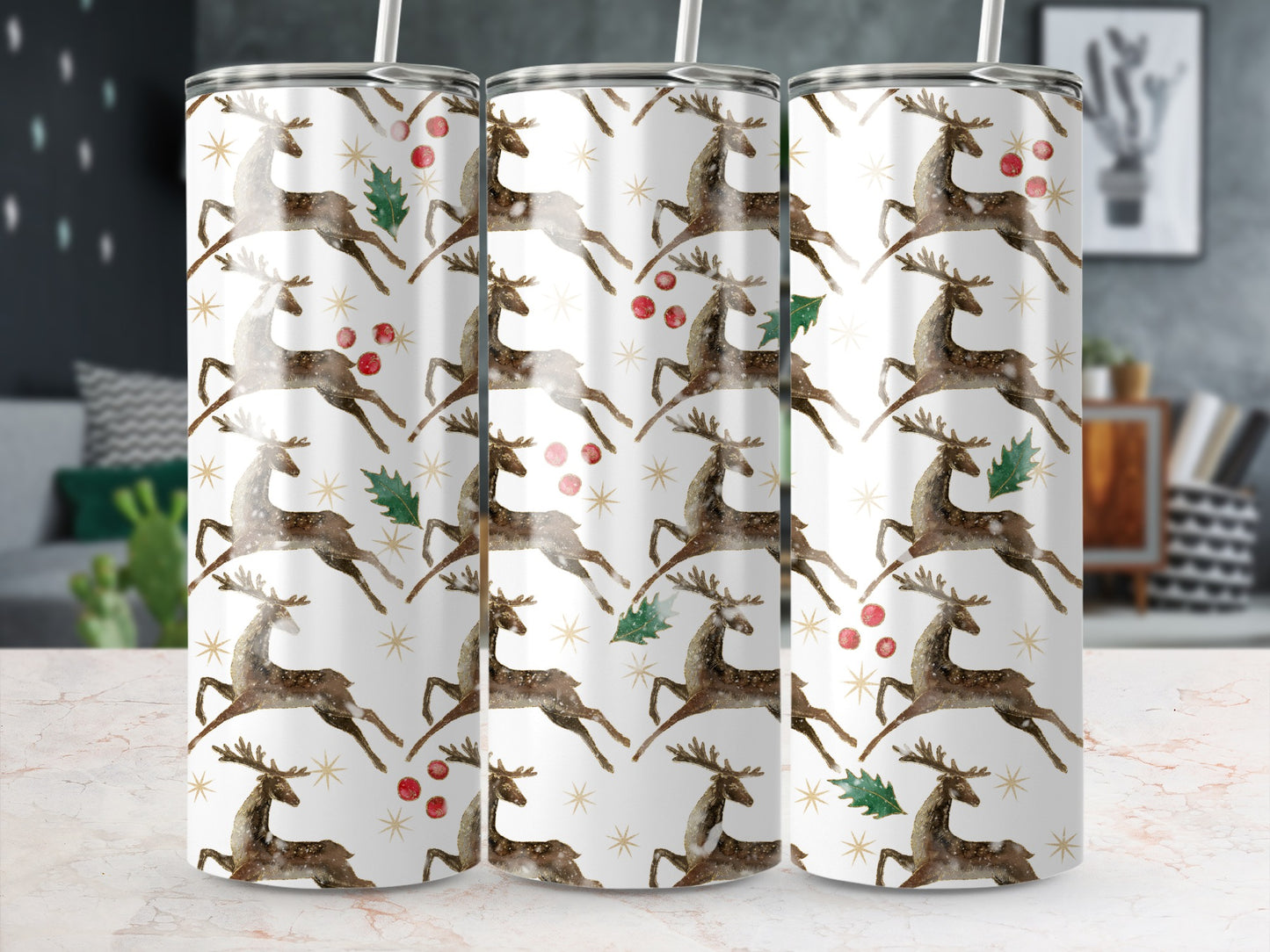 Three tumblers with a repeating pattern of reindeer, holly, and stars.