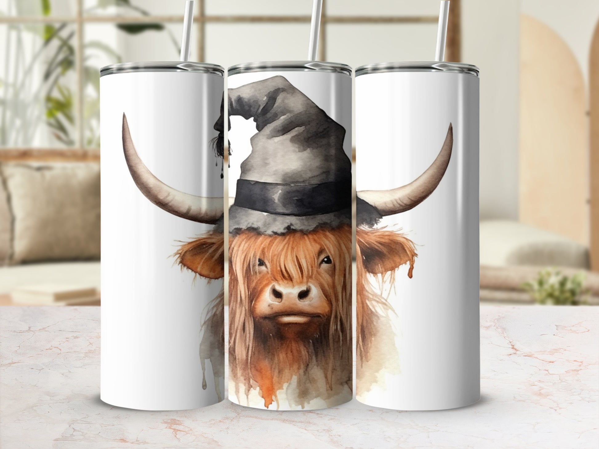 Highland cow wearing a witch hat on a white tumbler with straw.