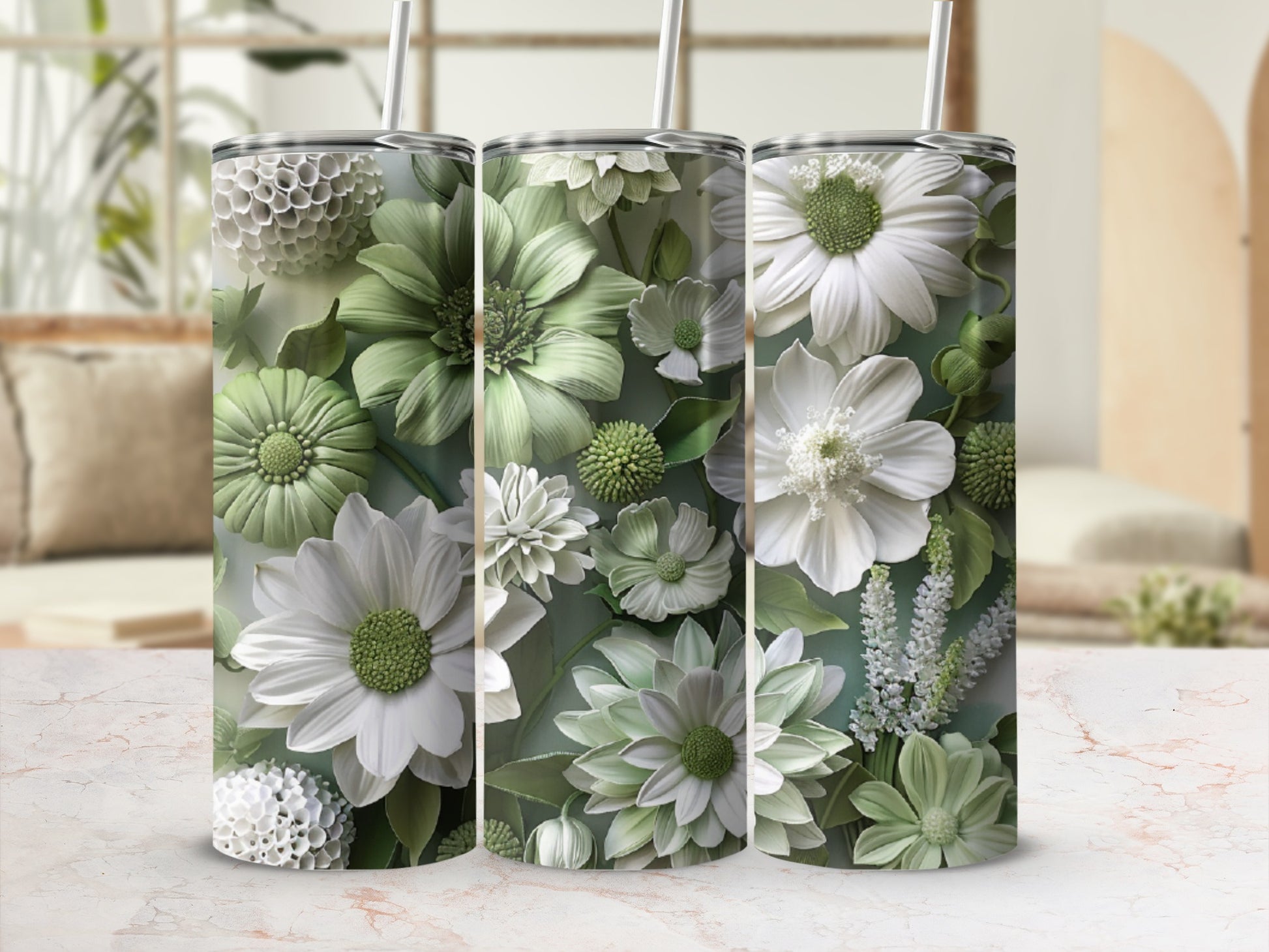 Three tumblers with detailed white and green floral patterns and straws.