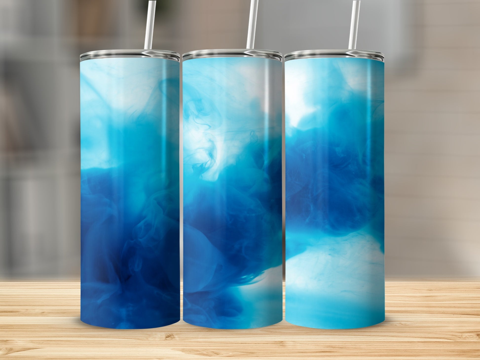 Three tall, clear tumblers with blue watercolor swirls design.