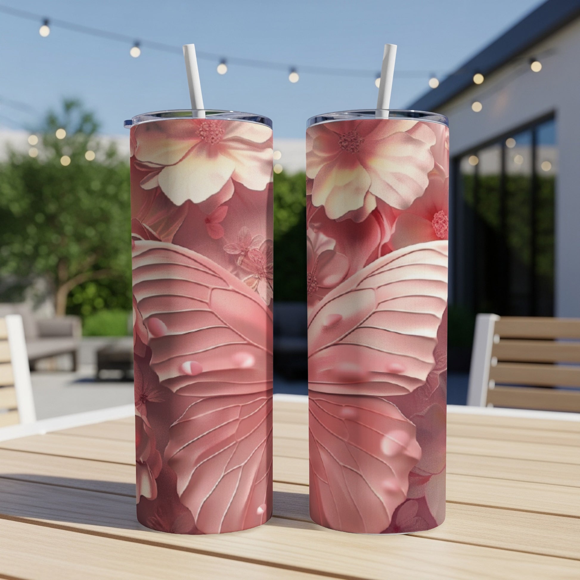 Two tall tumblers with pink butterfly wings and floral designs.