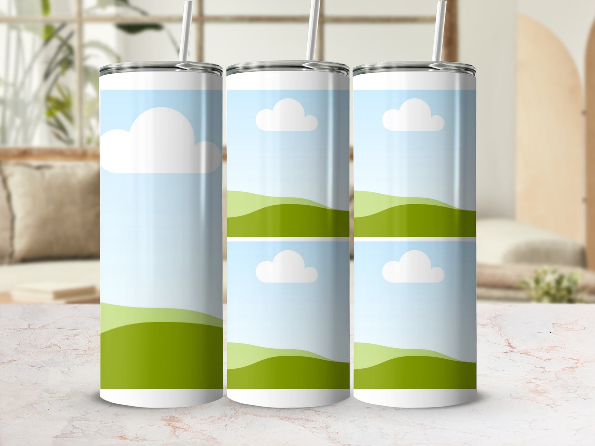 Three tumblers with a green landscape and white clouds design.