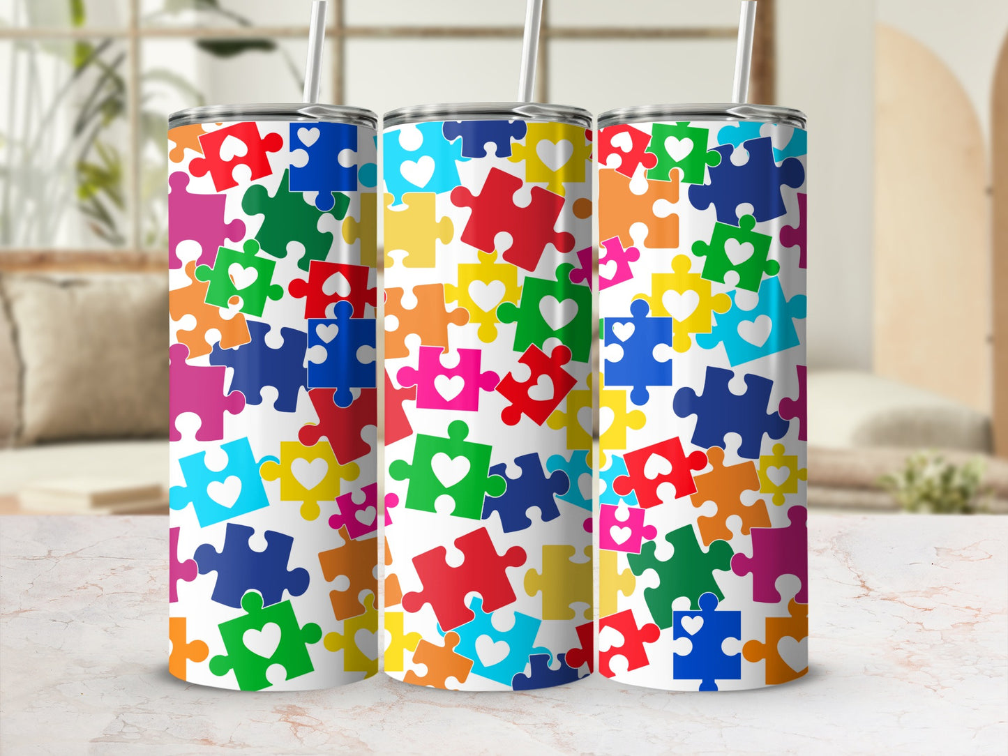 Colorful puzzle pieces with white hearts adorn three tumblers.
