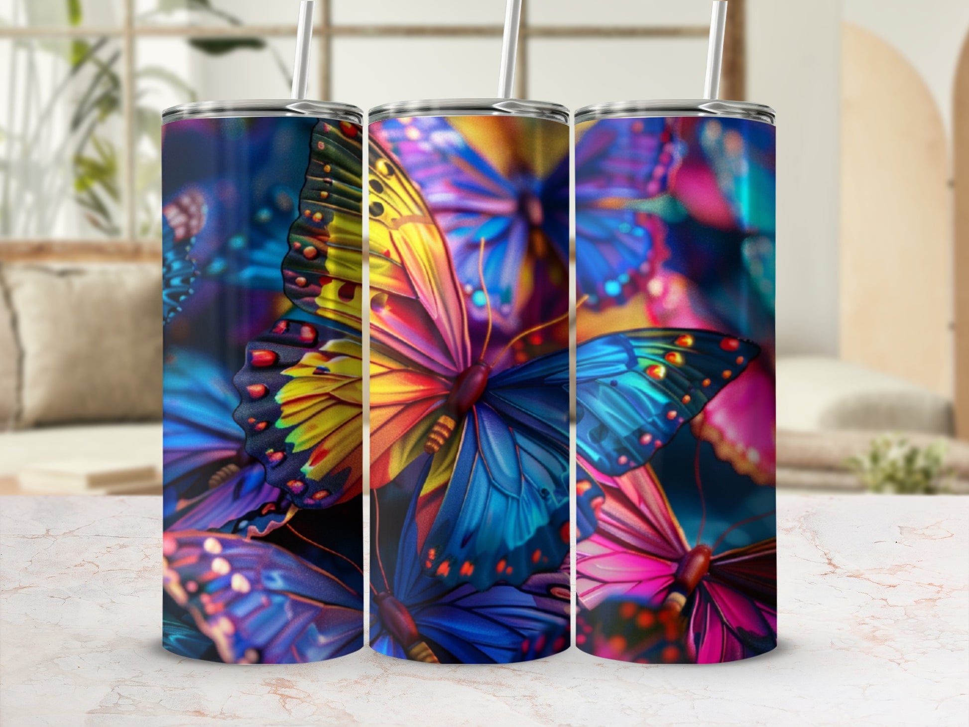 Three tumblers adorned with vibrant, colorful butterfly designs.