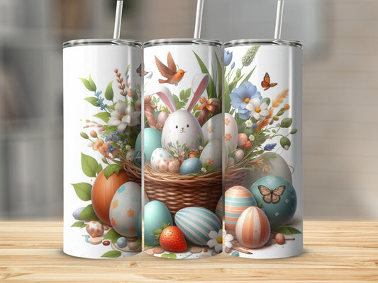 Easter basket with decorated eggs, bunnies, and flowers, three tumblers in foreground.