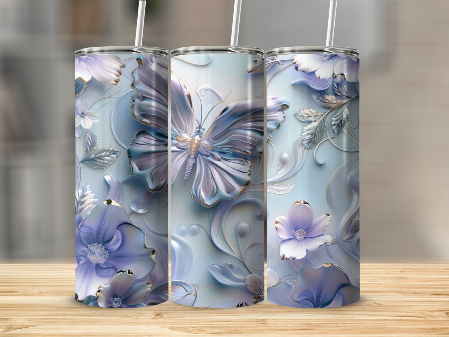 Three tumblers with embossed floral and butterfly designs in shades of blue and purple.