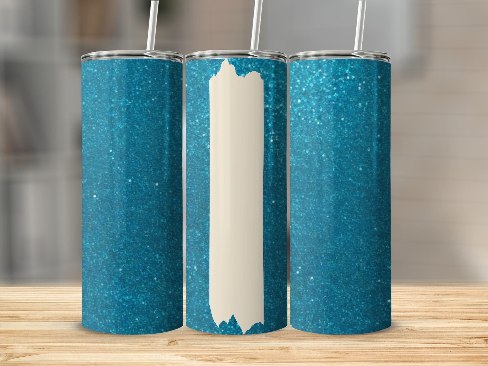 Three glittery blue tumblers with white straws and a blank section.