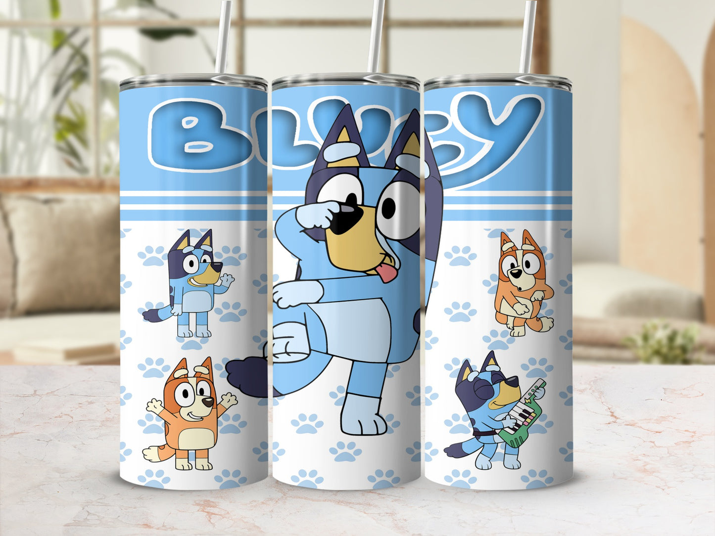 Bluey characters on a blue tumbler with paw print pattern.