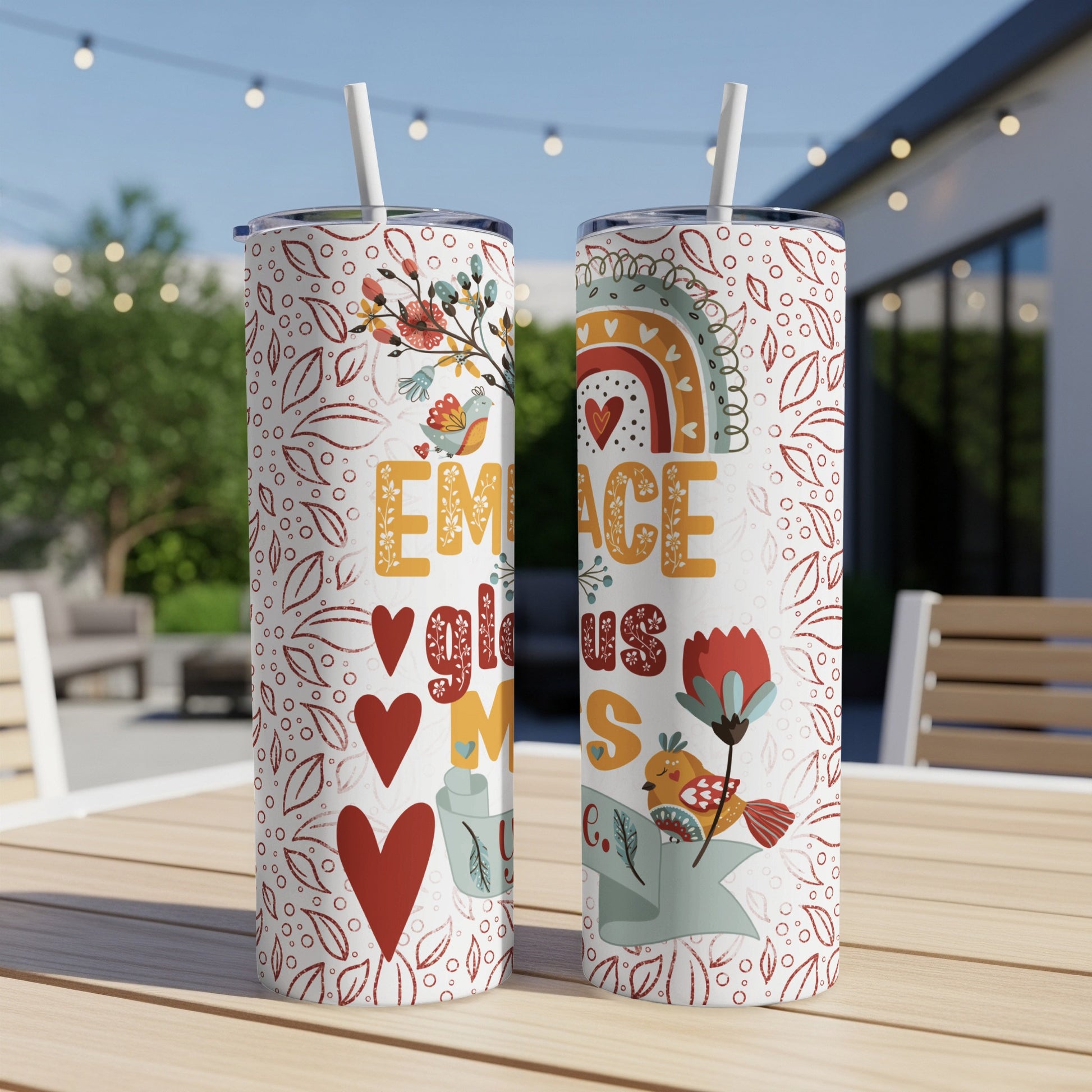 Two tumblers with rainbow, heart, and bird illustrations and "EMBRACE JOY" text.