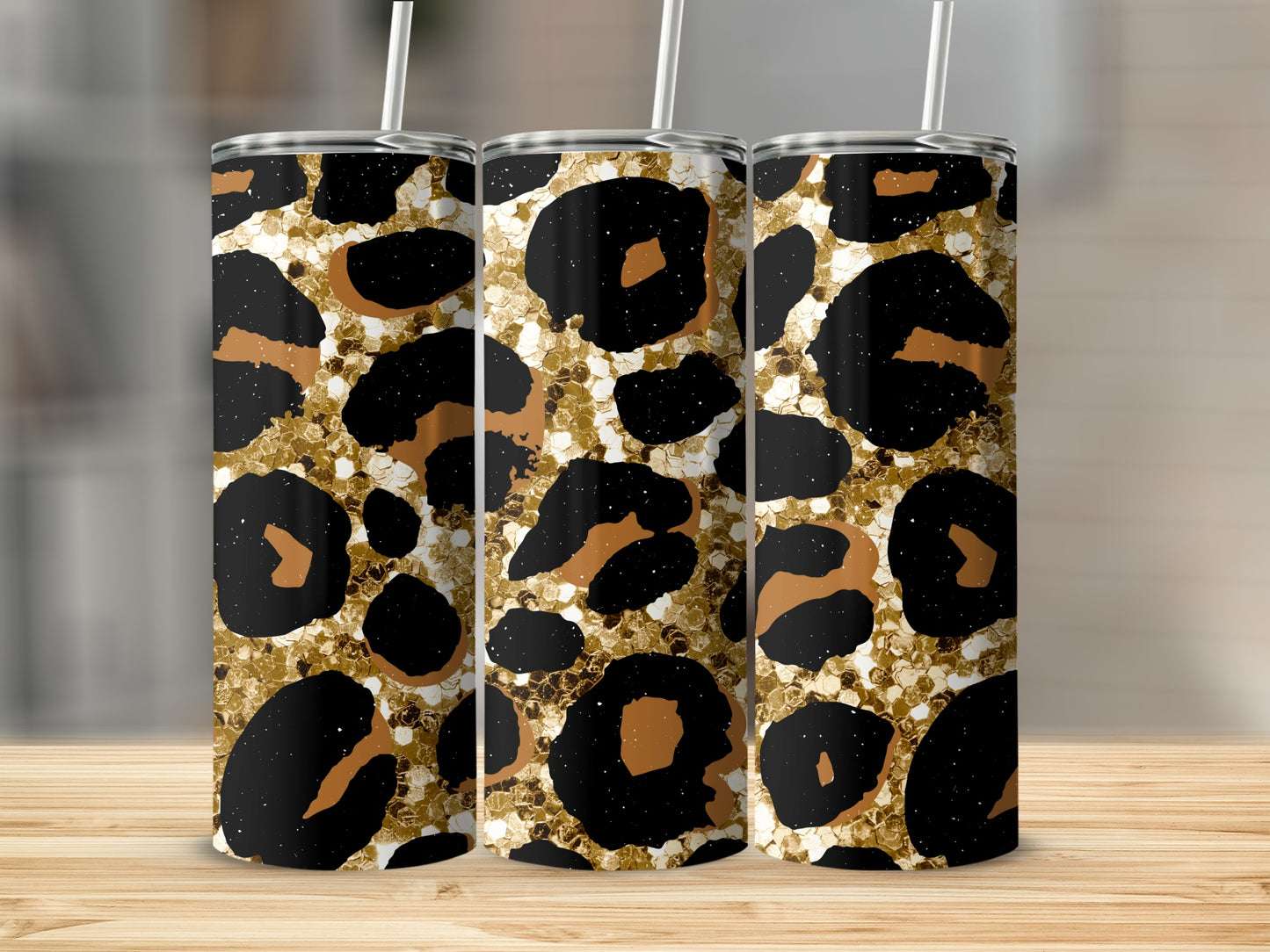 Three tumblers with gold glitter and black and tan leopard print patterns.