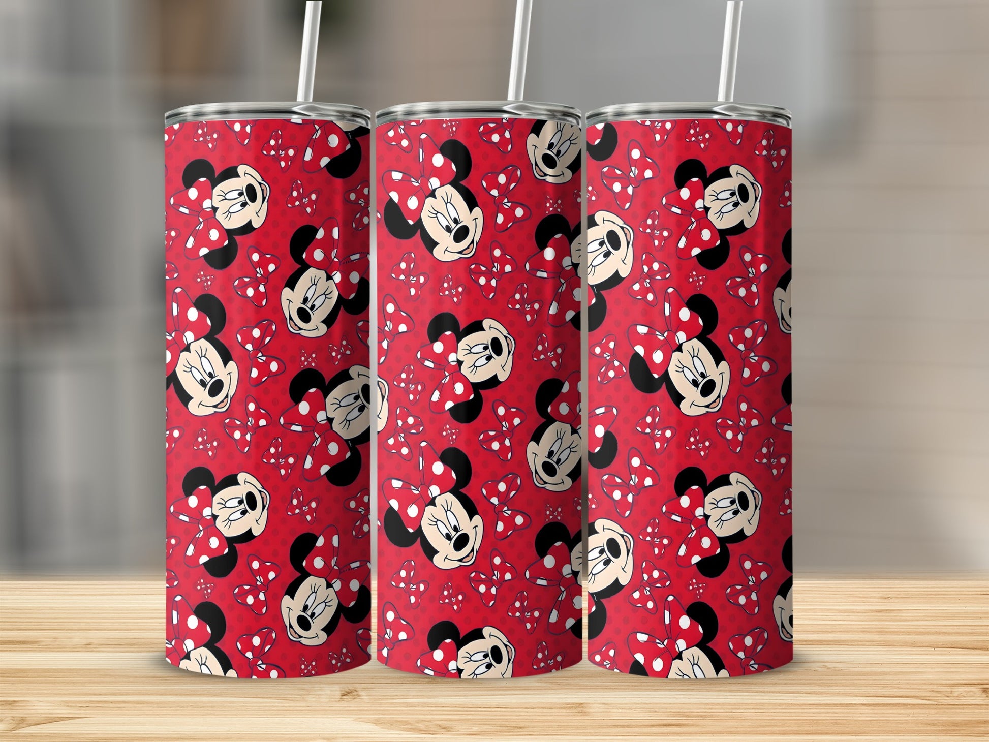 Minnie Mouse pattern on three red stainless steel tumblers with straws.