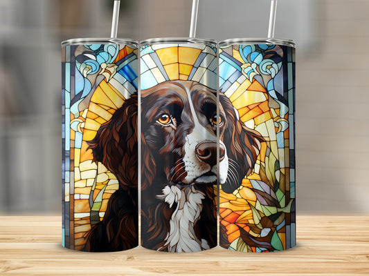 Stained glass dog portrait tumbler with straw on wooden surface.