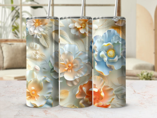 Three floral patterned tumblers with lids and straws on a counter.