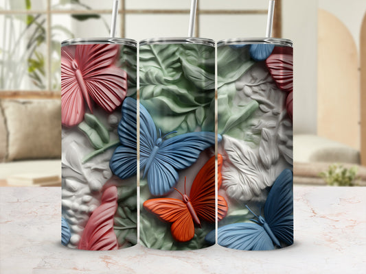 Three tumblers with colorful butterfly and floral embossed designs.