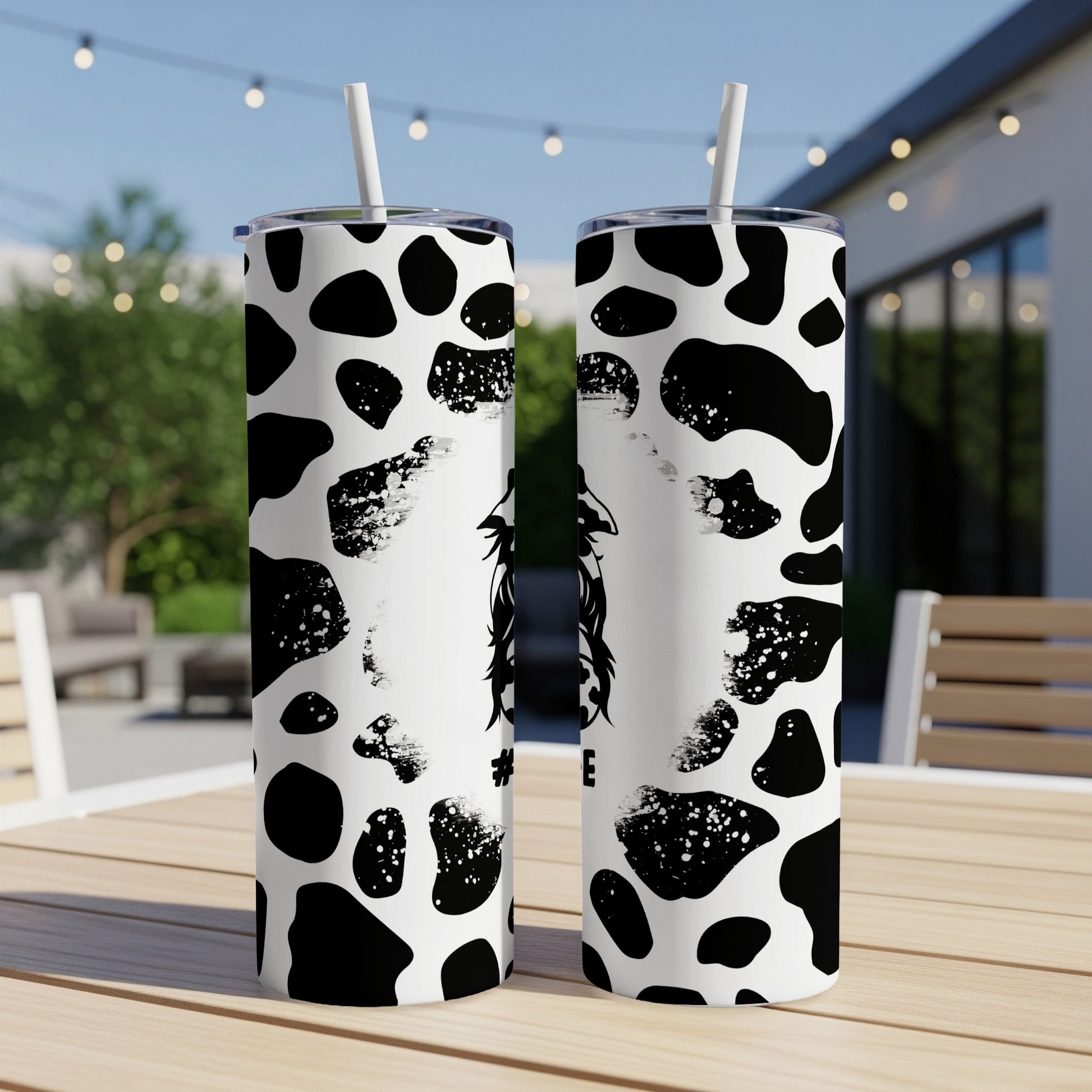 Two tumblers with black and white cow print pattern, one featuring a silhouette of a cow.