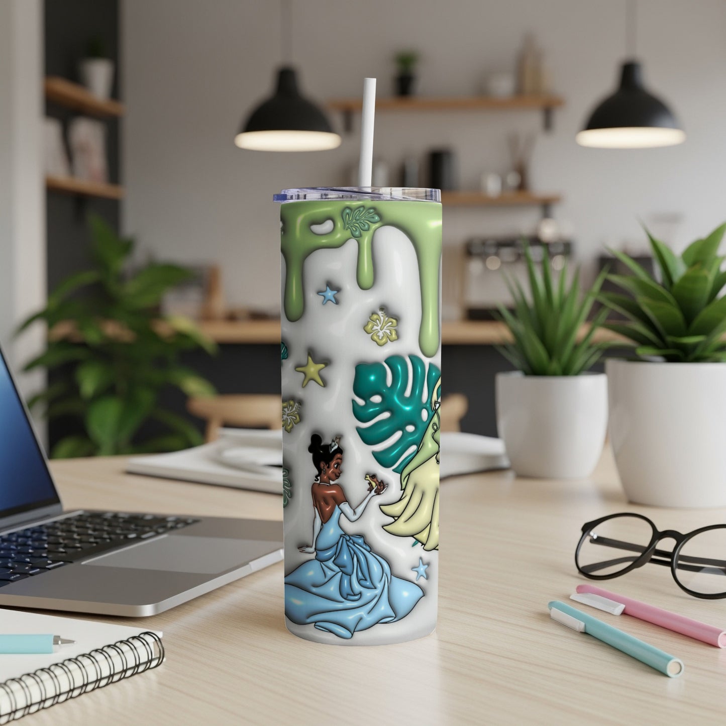Tiana in blue dress with crown and leaves on white tumbler with straw.