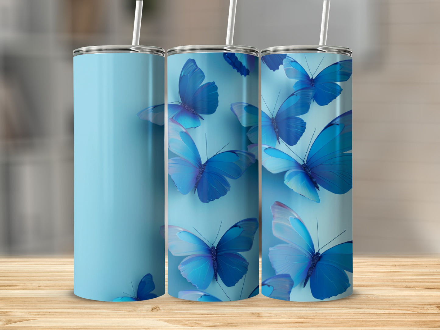 Three light blue tumblers with blue butterfly designs.