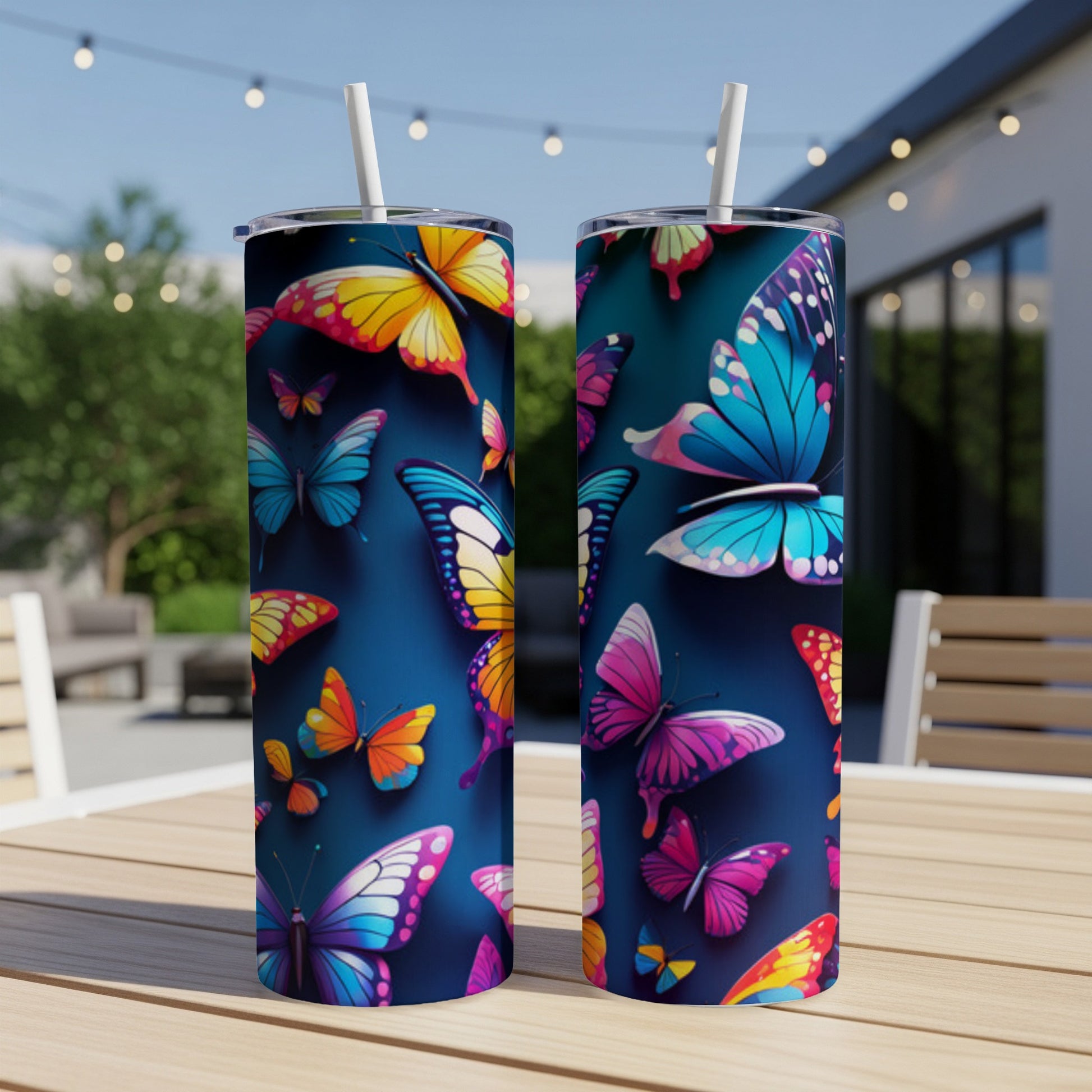 Two tumblers with colorful butterfly patterns on a wooden table.
