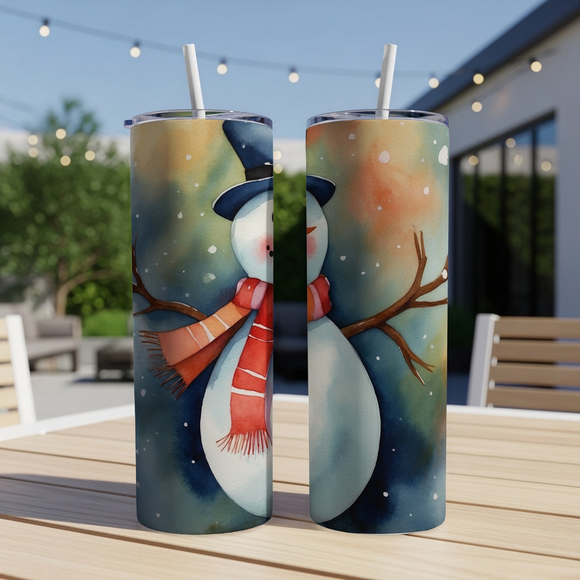 Two snowmen with hats and scarves on a table.