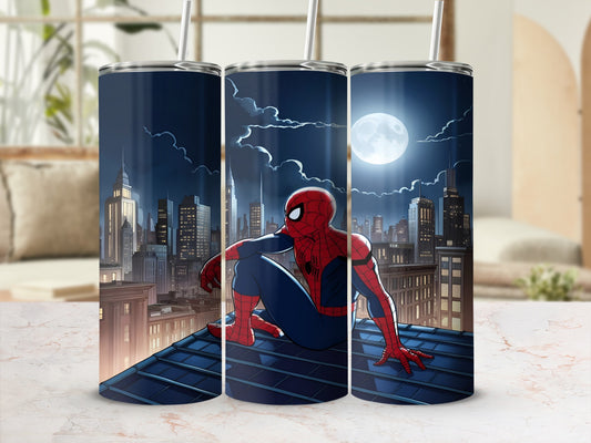 Spiderman sitting on a rooftop overlooking a city at night.