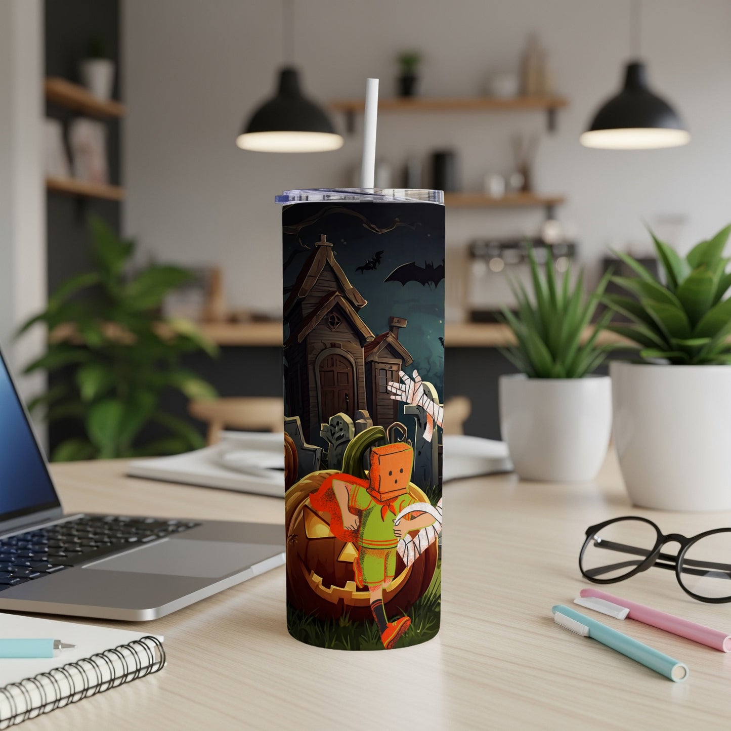Halloween tumbler featuring a pumpkin, haunted house, bats, and a costumed figure.