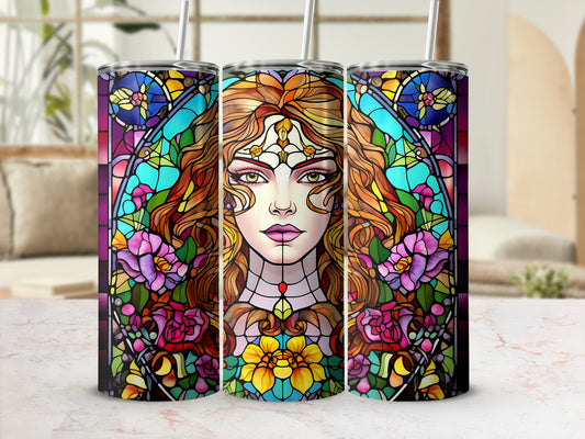 Stained glass tumbler featuring a woman's face and floral designs.