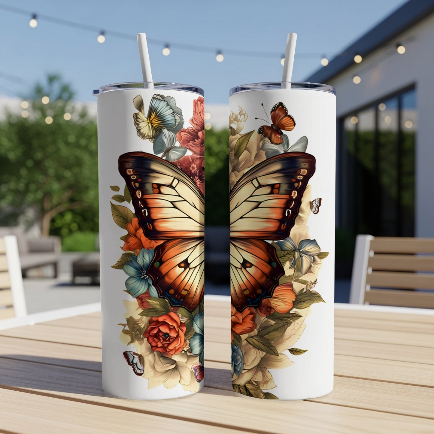 Two stainless steel tumblers with a butterfly and floral design.