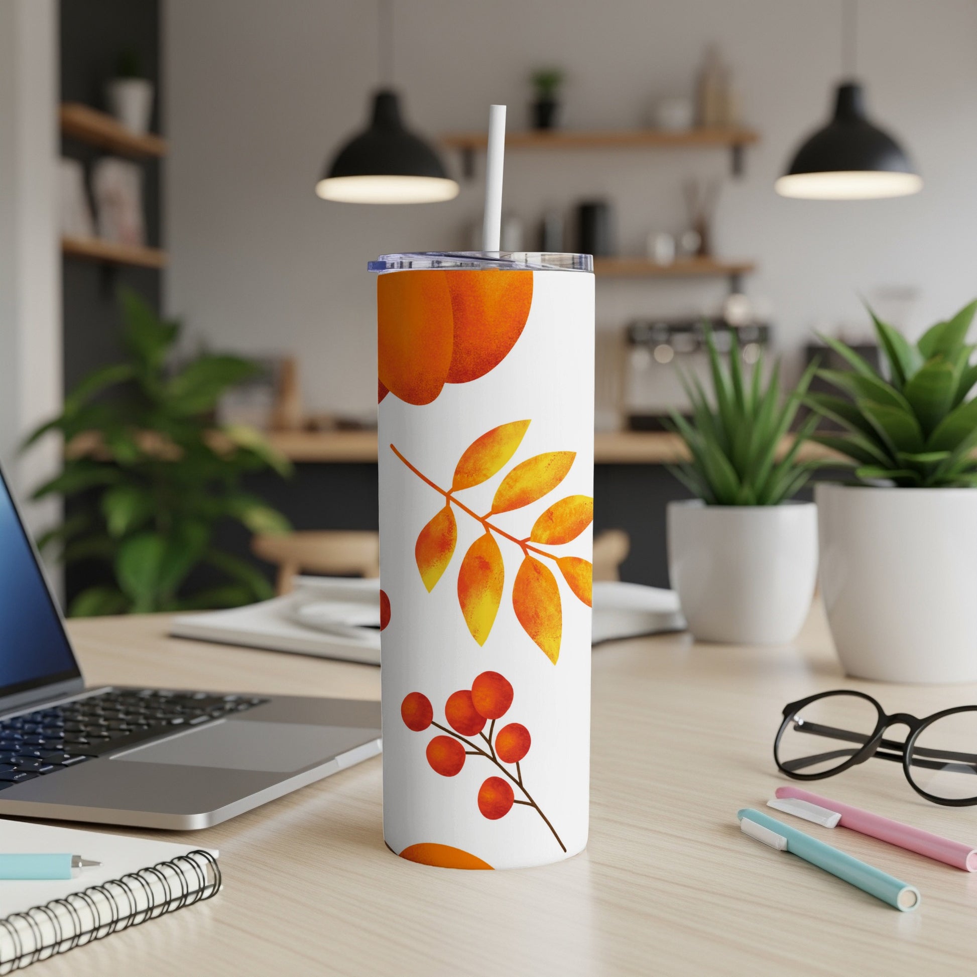 White tumbler with falling leaves and berries pattern.