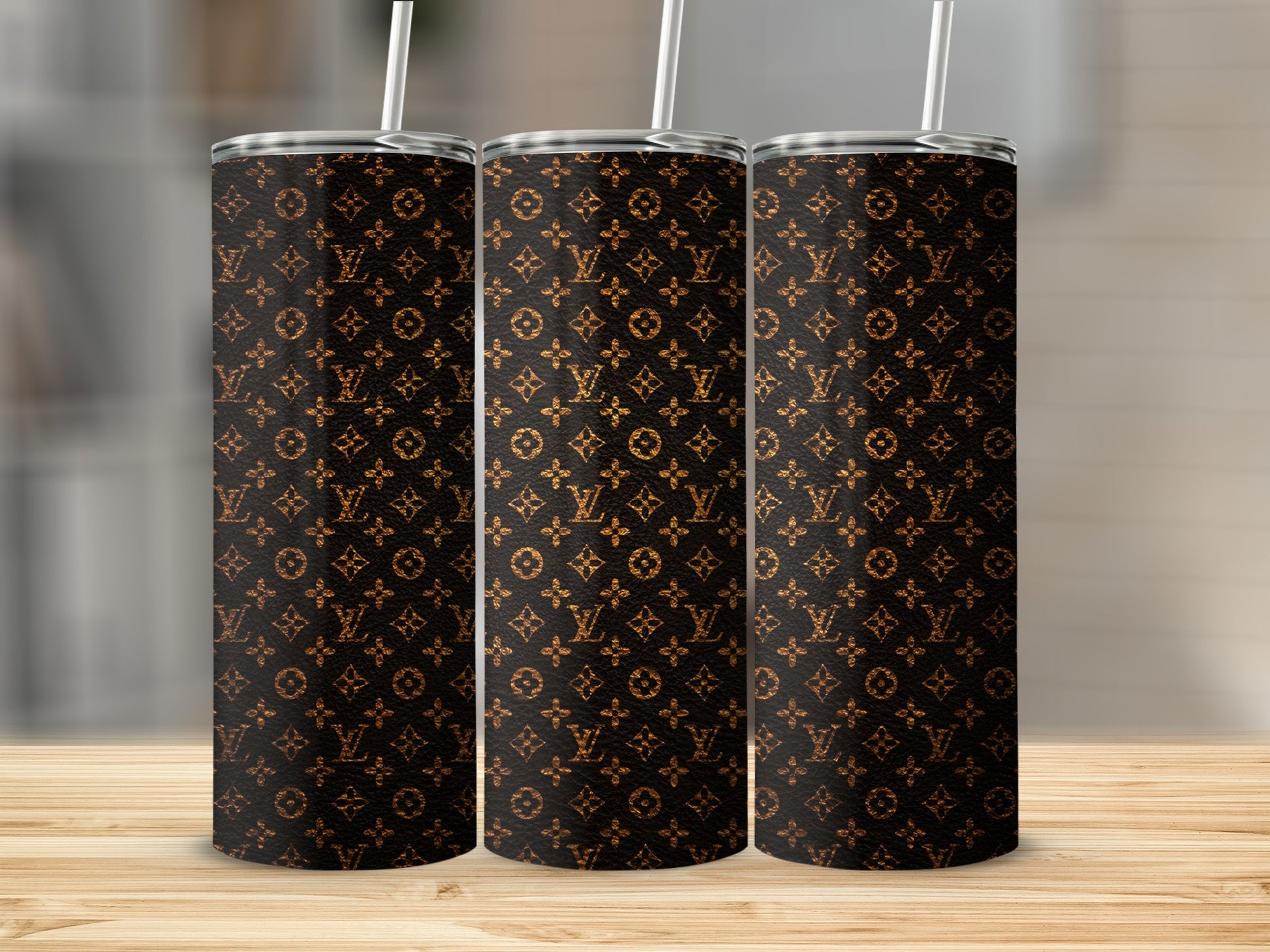 Three tumblers with a repeating brown LV monogram pattern.