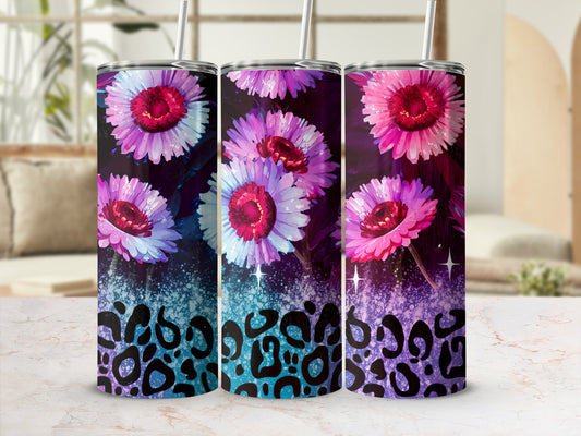 Three tumblers with floral and leopard print designs on a marble surface.