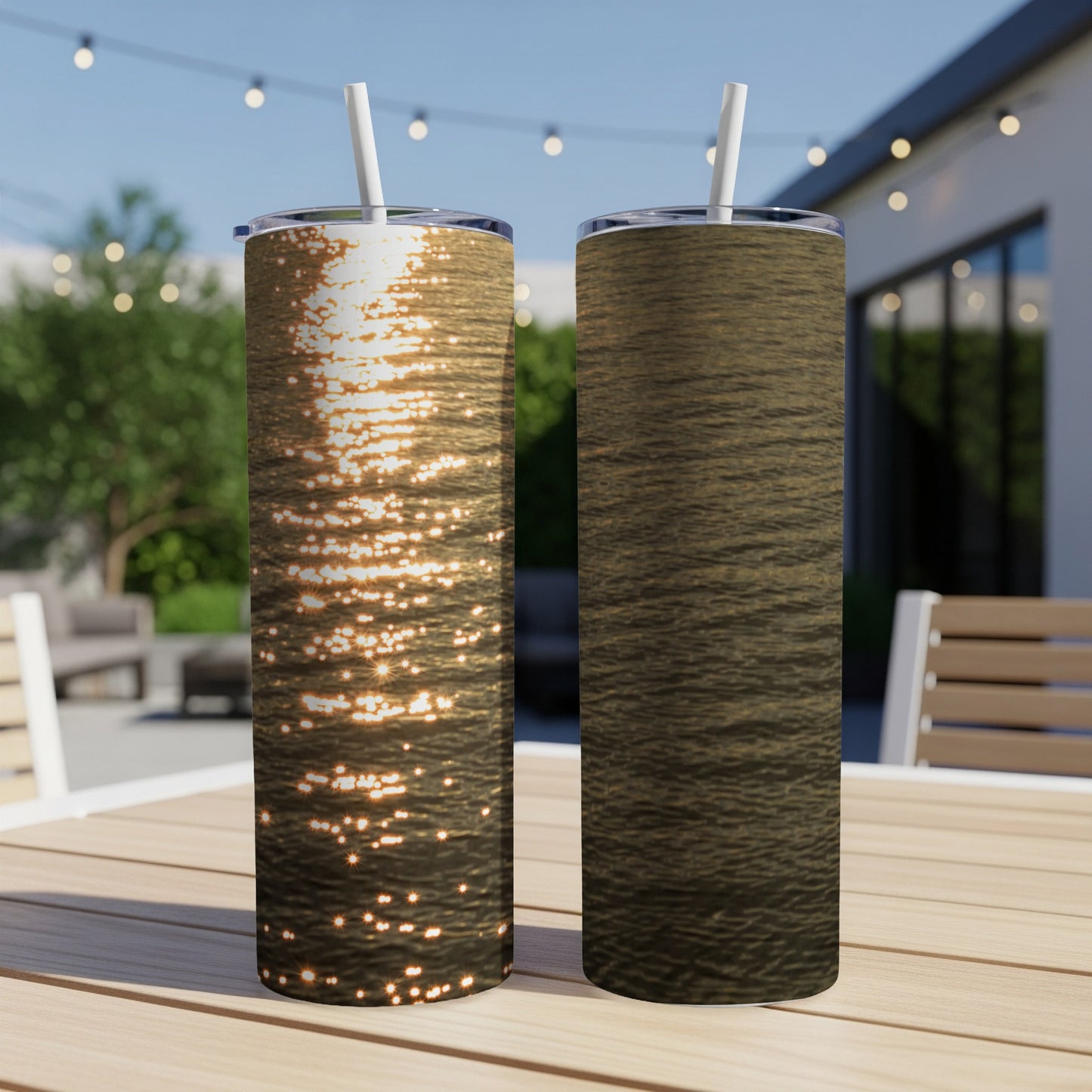 Two tumblers with water reflections and textured patterns sit on a wooden table outdoors.