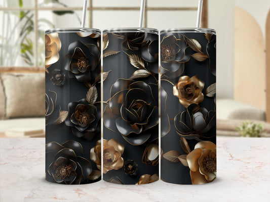 Three black tumblers with metallic floral designs against a blurred background.
