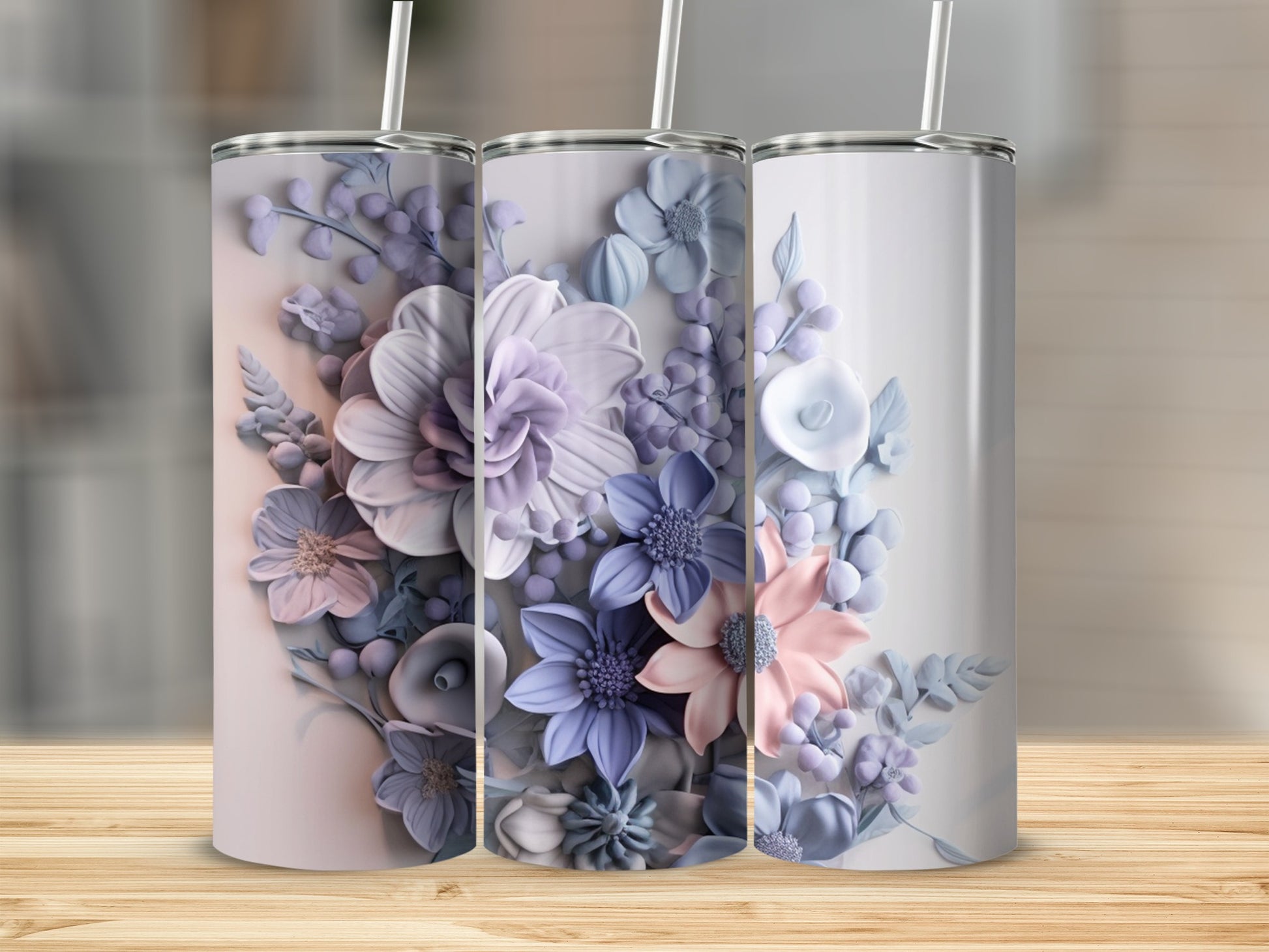 Three floral tumblers with pastel purple, blue, and pink floral designs.
