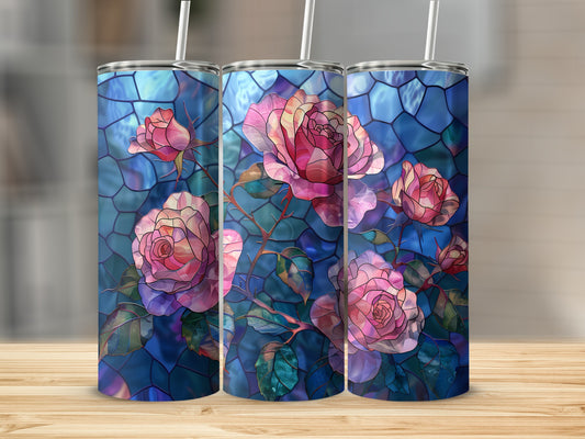 Three tumblers with stained glass rose design on a wooden surface.
