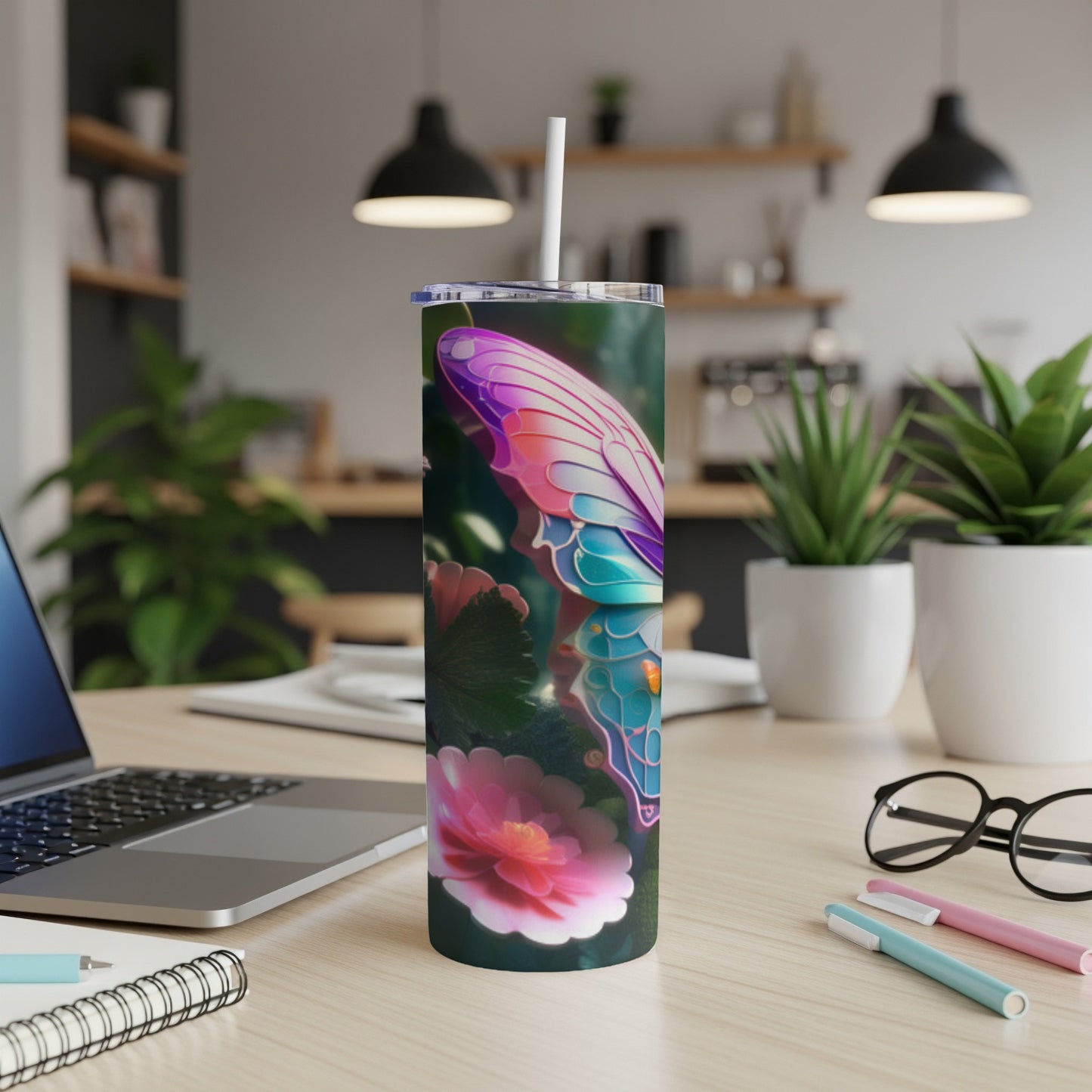 Butterfly and flower design on a tall, skinny tumbler with a straw.