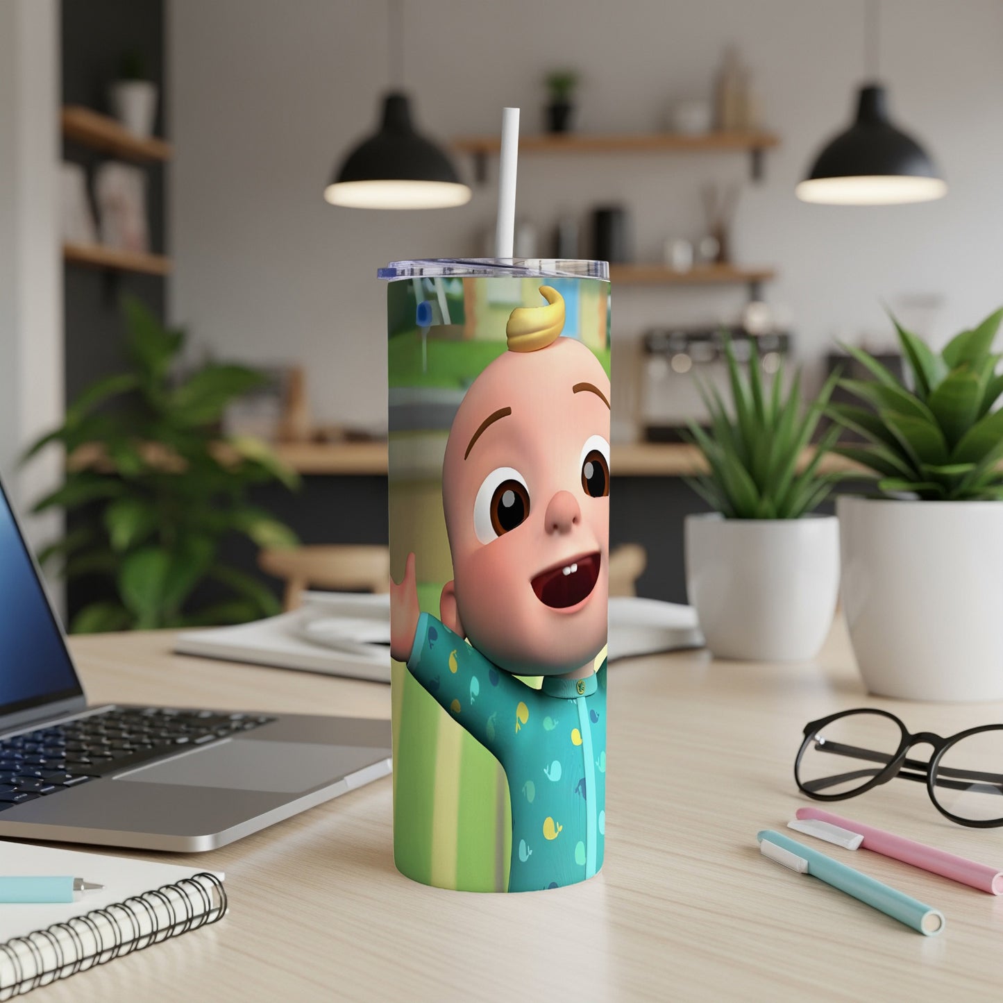 JJ from Cocomelon waving on a blue patterned tumbler with straw.