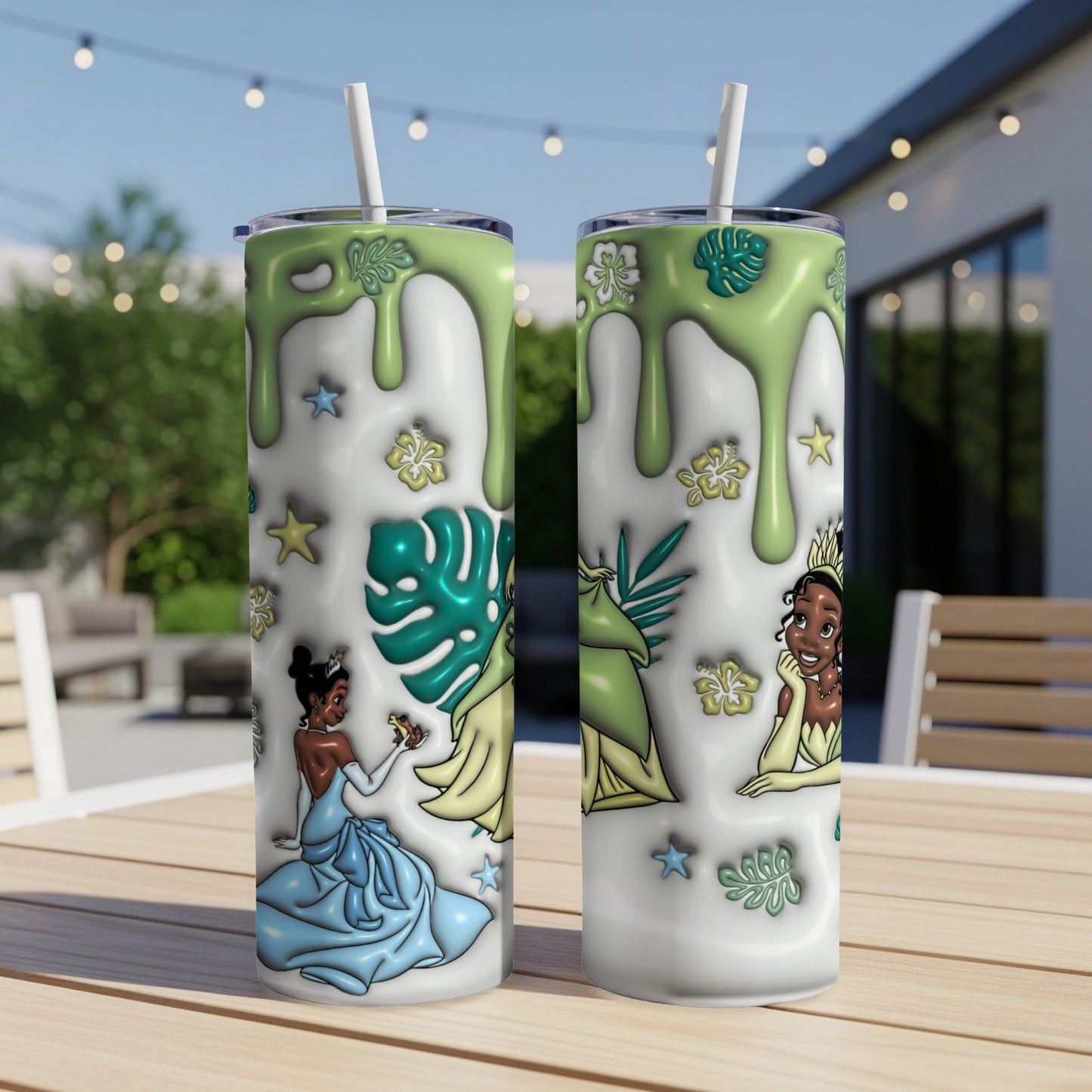 Two Princess Tiana tumblers with green dripping designs and tropical leaves.