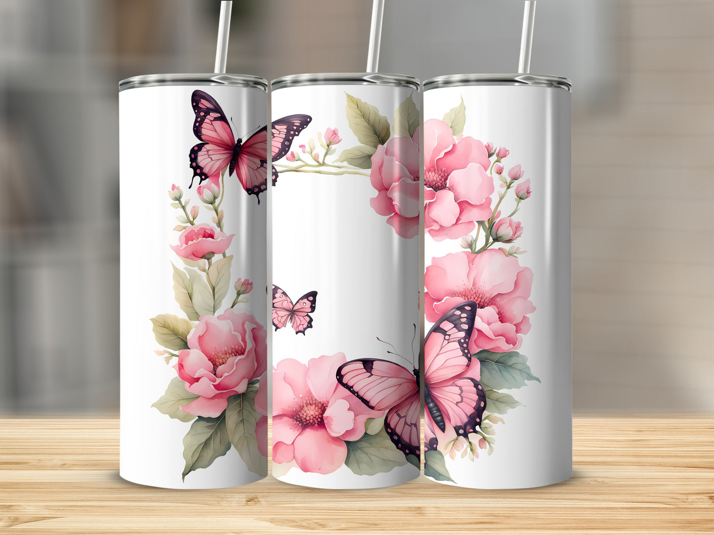 Three white tumblers decorated with pink flowers and butterflies.