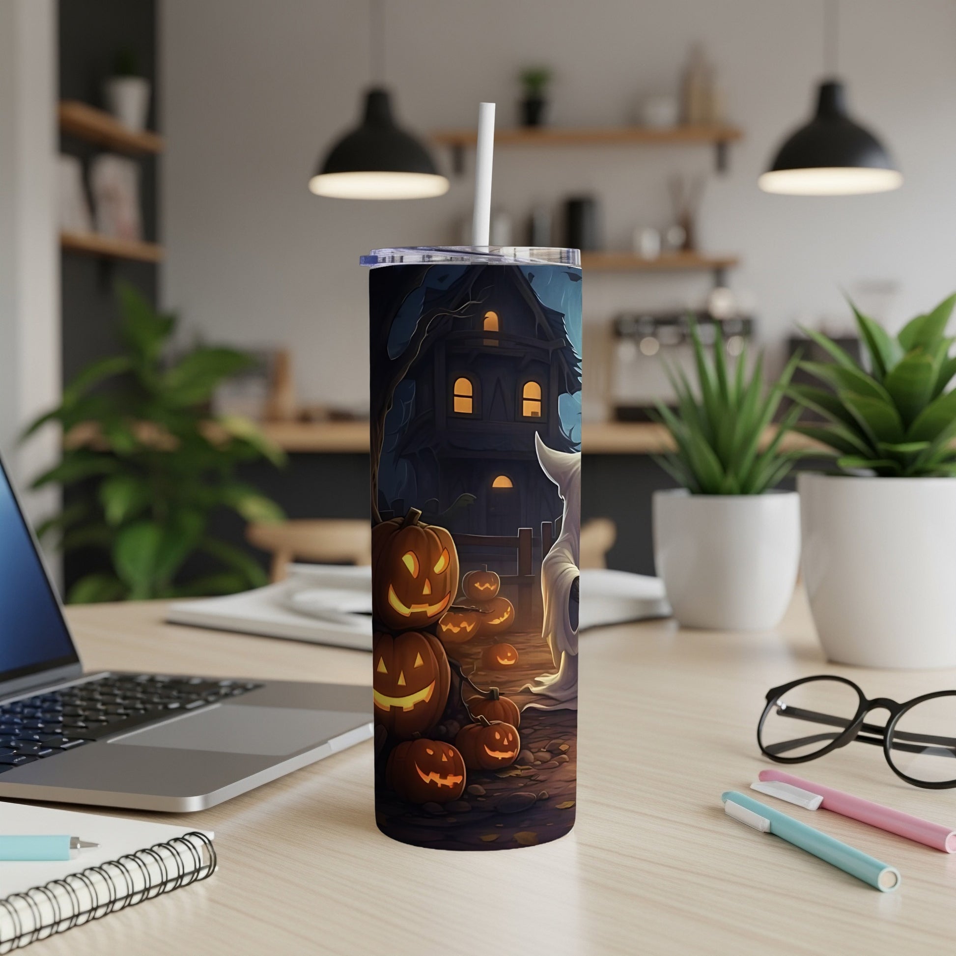 Tall tumbler with Halloween scene of haunted house, pumpkins, and ghost.