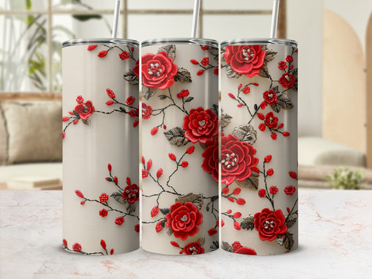 Beige tumbler with red embroidered floral design and leaves.